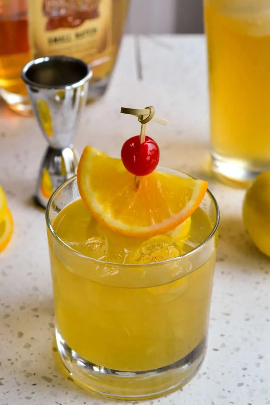 Ice cold whiskey sour over ice with a garnish