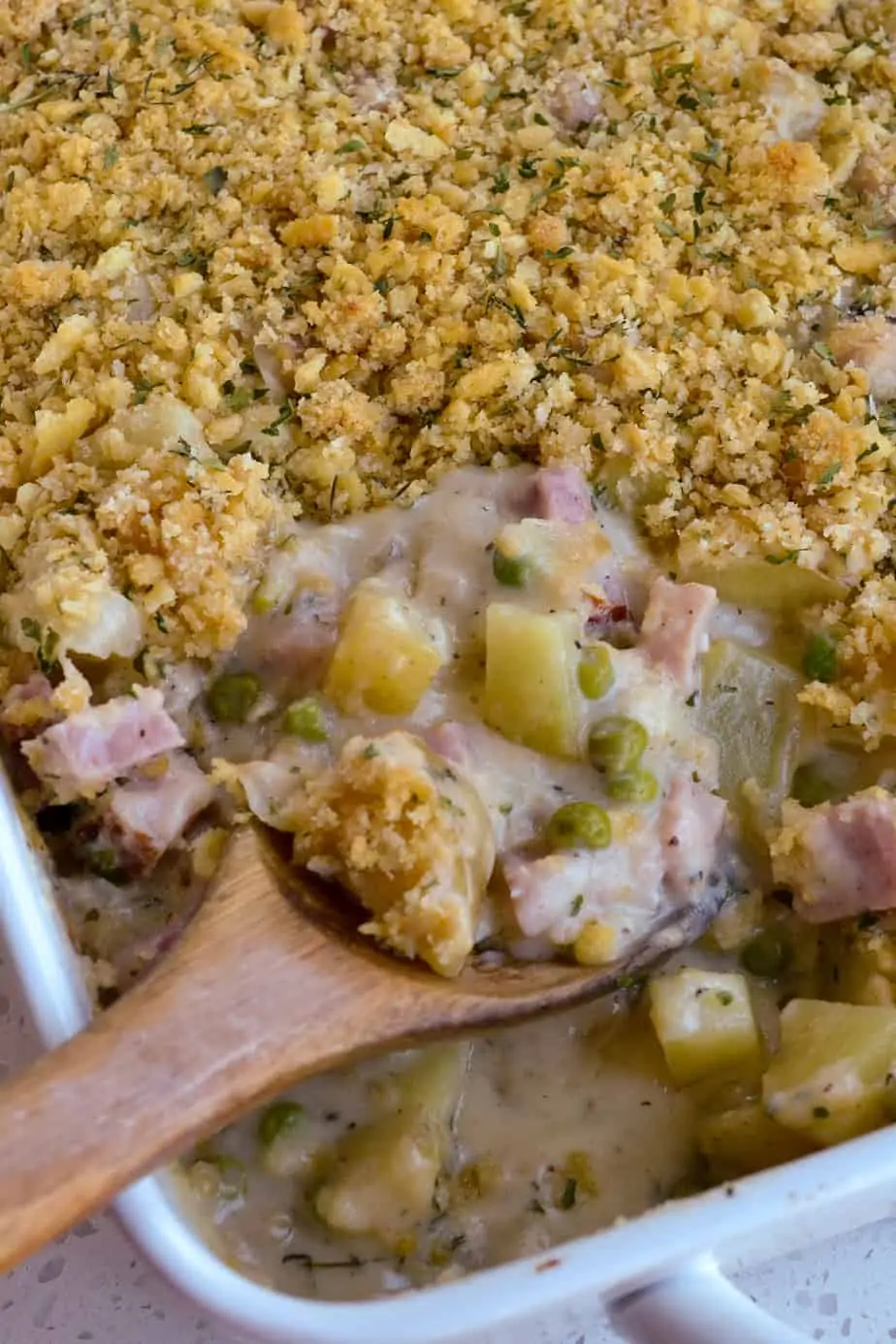 A spoonful of ham, cheese and potato casserole with a buttery cracker crumb topping. 