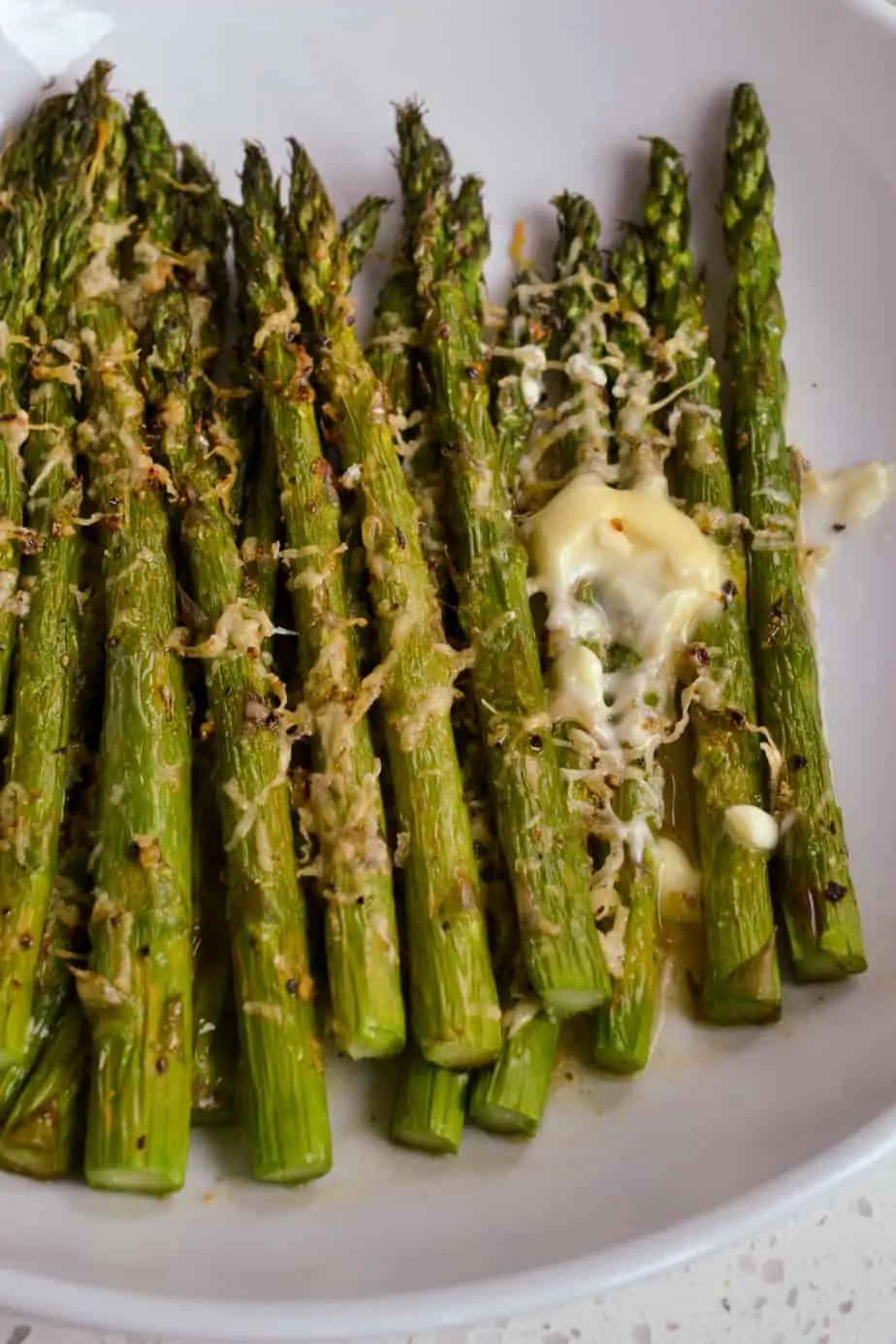 Easy air fryer asparagus with Parmesan Cheese and butter. 