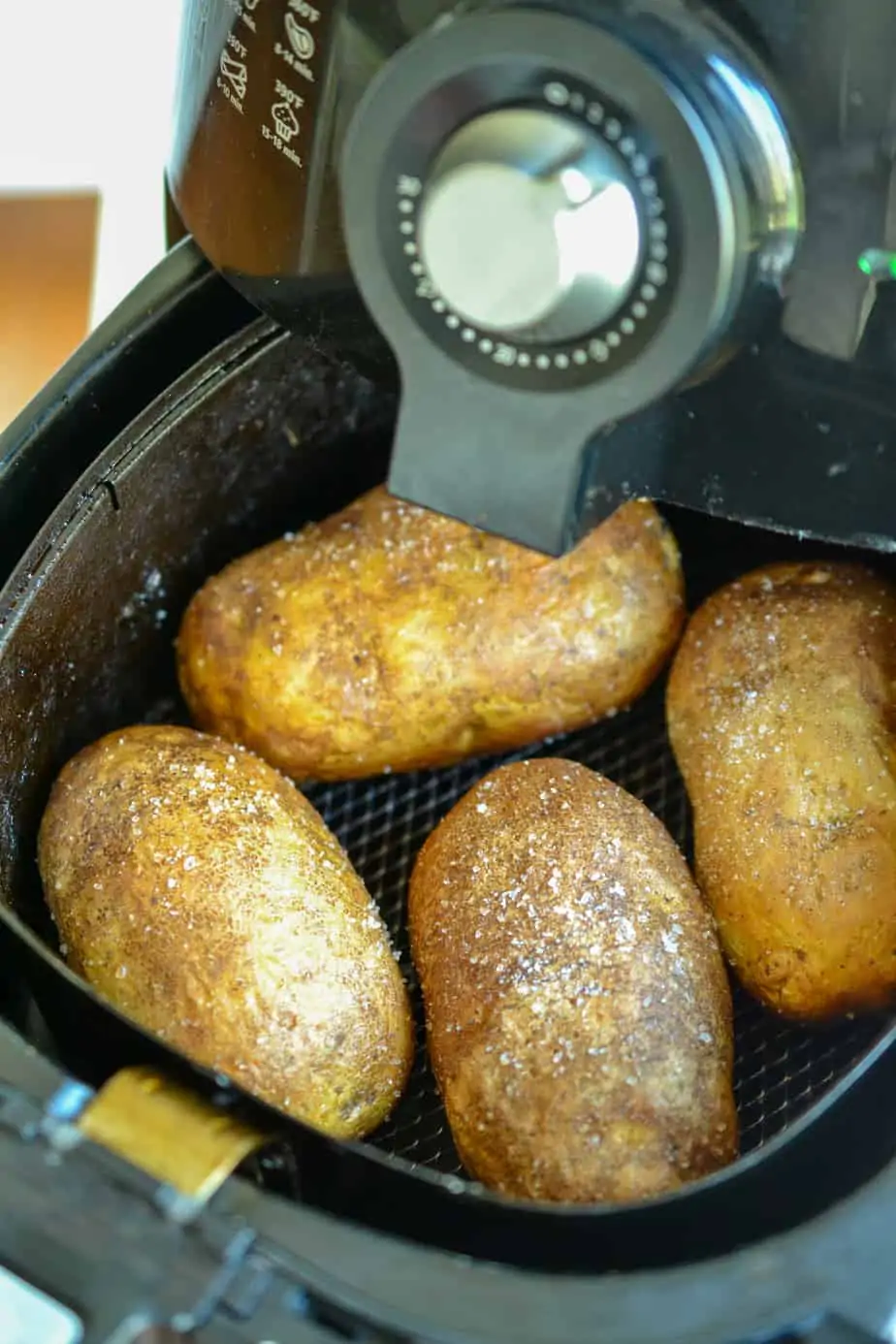 Four potatoes in an air fryer. 