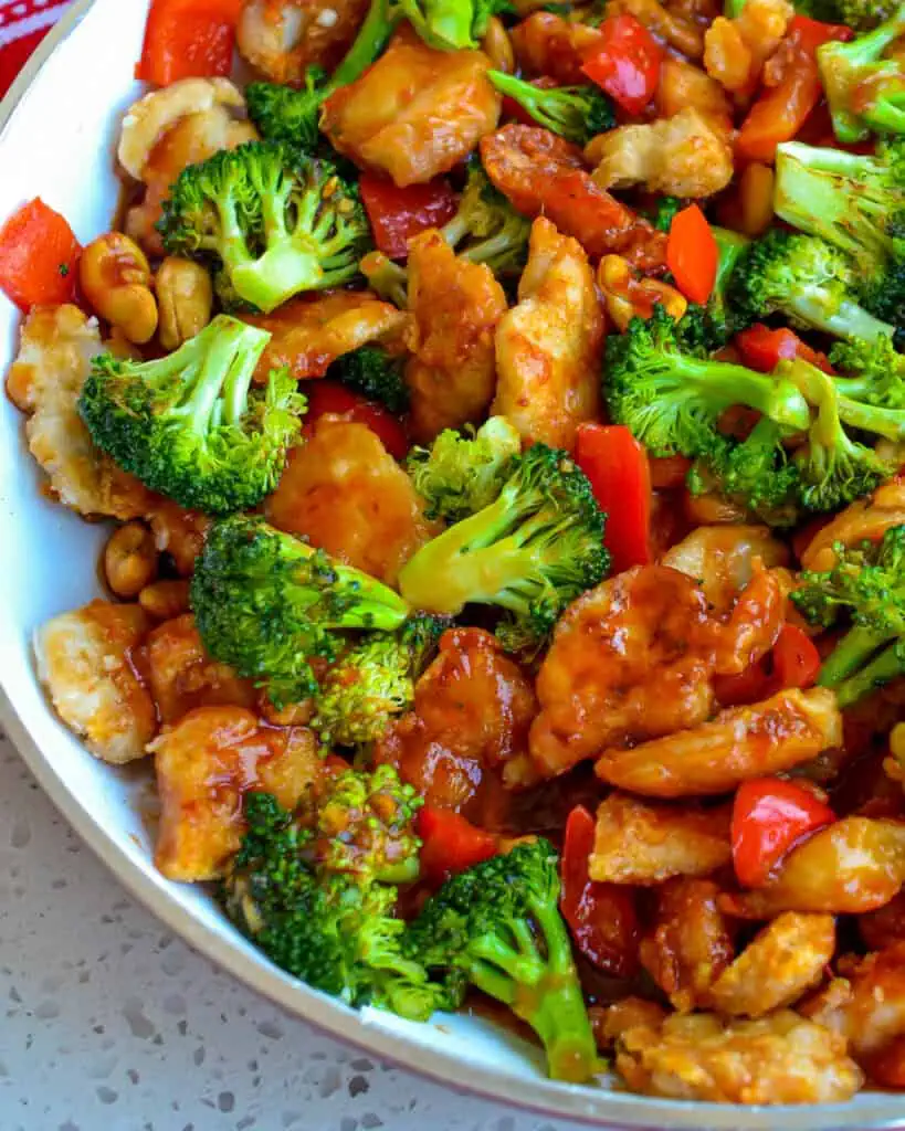 A close up view of cashew chicken in a skillet. 