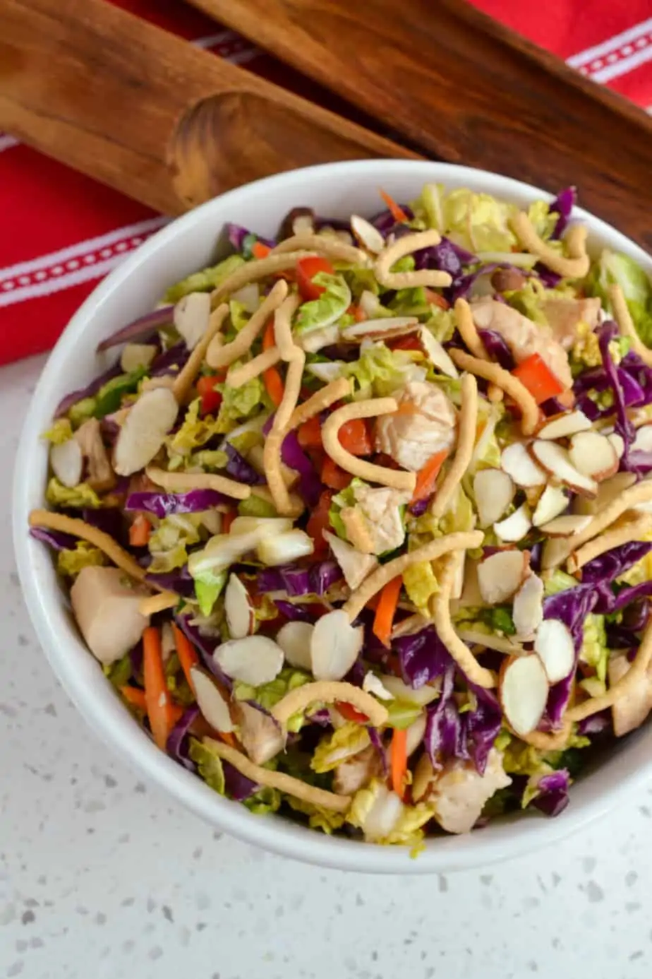 Oriental Chinese chicken salad with almonds, chow mein noodles, carrots, and red bell peppers. 