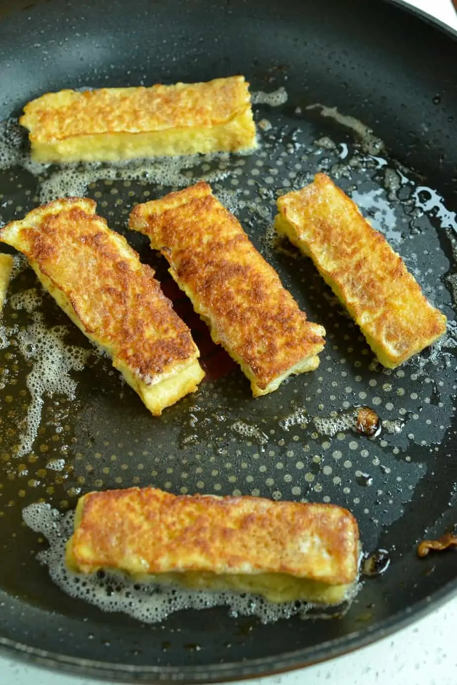 Pan frying egg battered bread. 