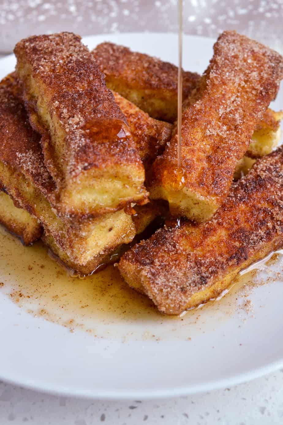 Maple syrup poured on homemade French Toast Sticks. 
