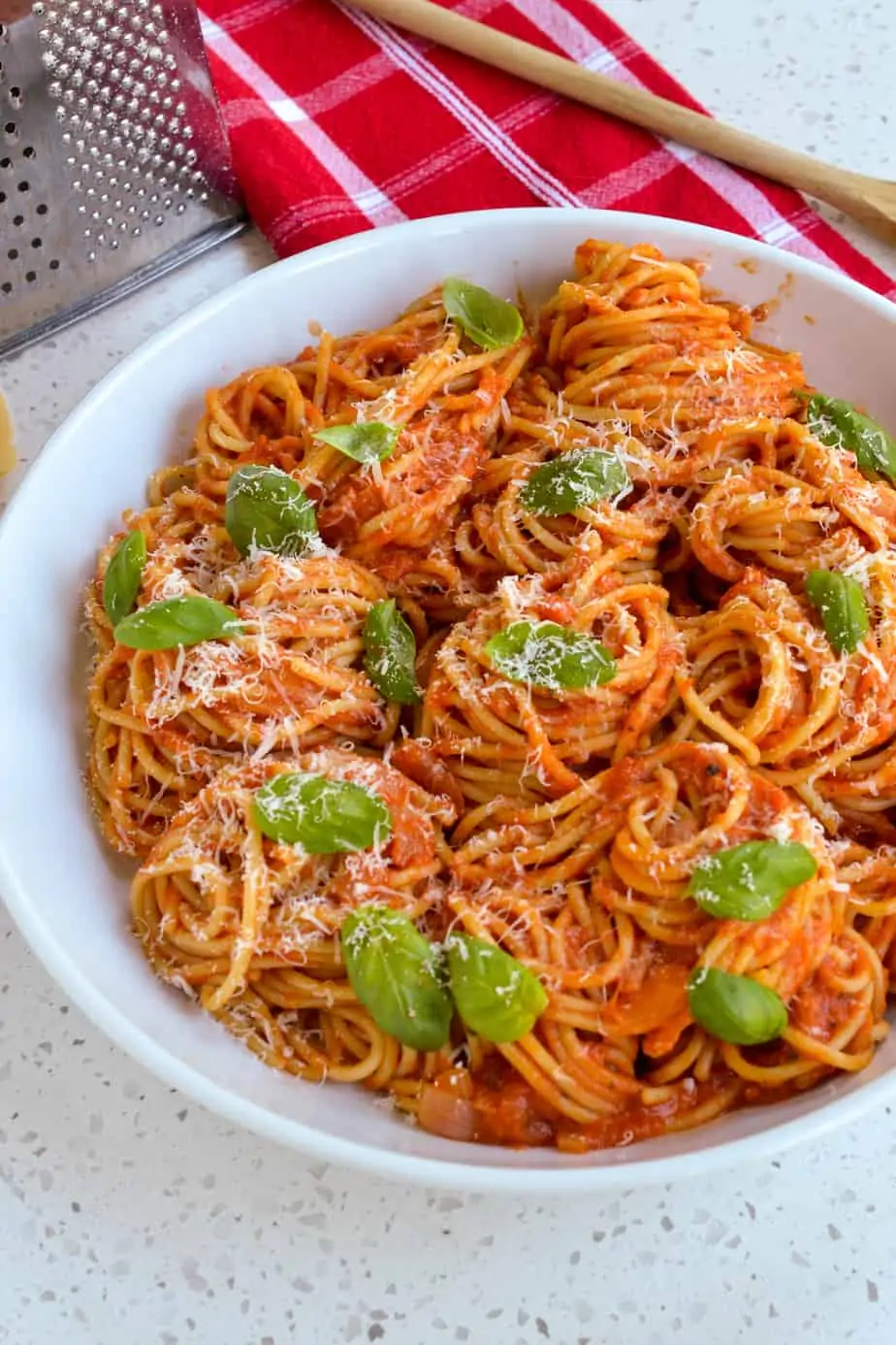 Pasta with tomato sauce topped with fresh basil and Parmesan Cheese