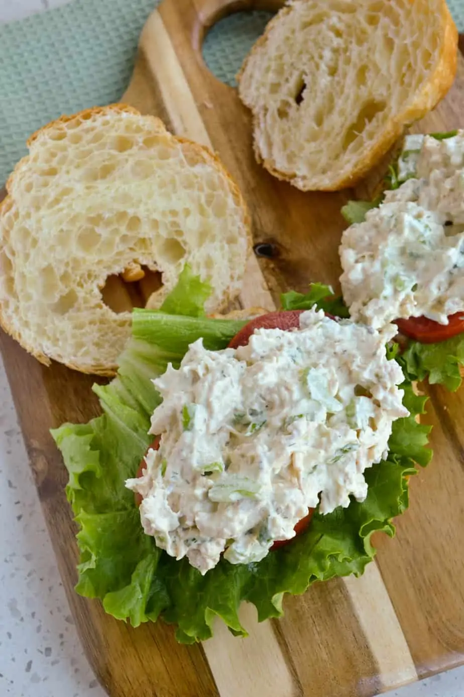 Chicken salad on top of lettuce and tomato. 