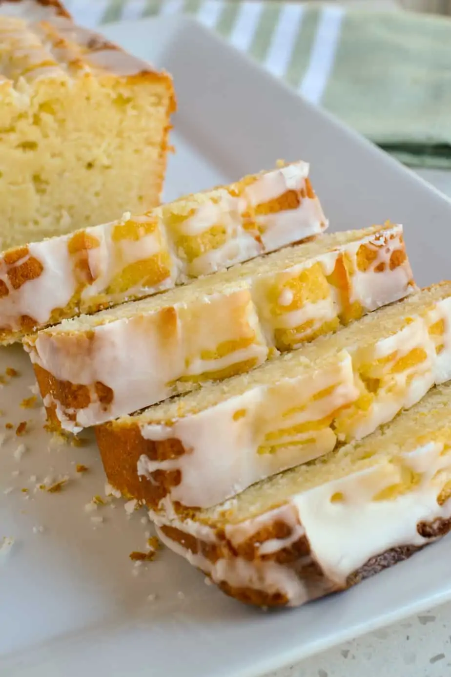 Slices of lemon glazed pound cake on a platter. 