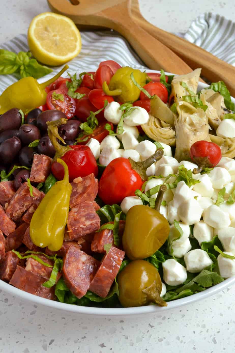 Italian salad with fresh mozzarella, salami, Kalamata olives, artichoke hearts, and peperoncini. 