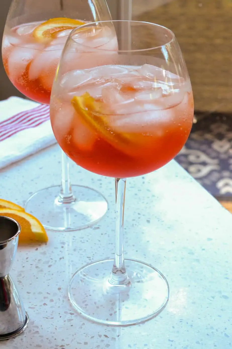 Aperol spritz in big bowl wine glasses with orange slices. 