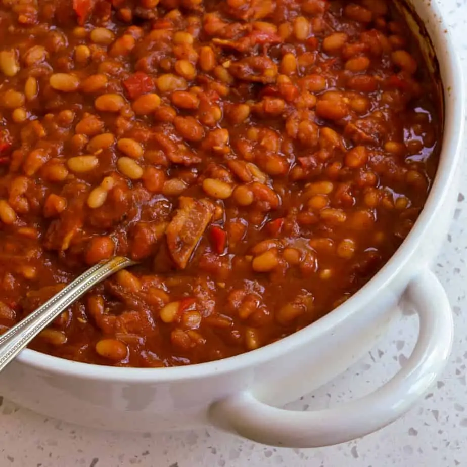 The best homemade Boston Baked Beans are made with dried navy beans, smoky bacon, sweet red bell peppers, onions, and garlic in a sweet and tangy tomato sauce.