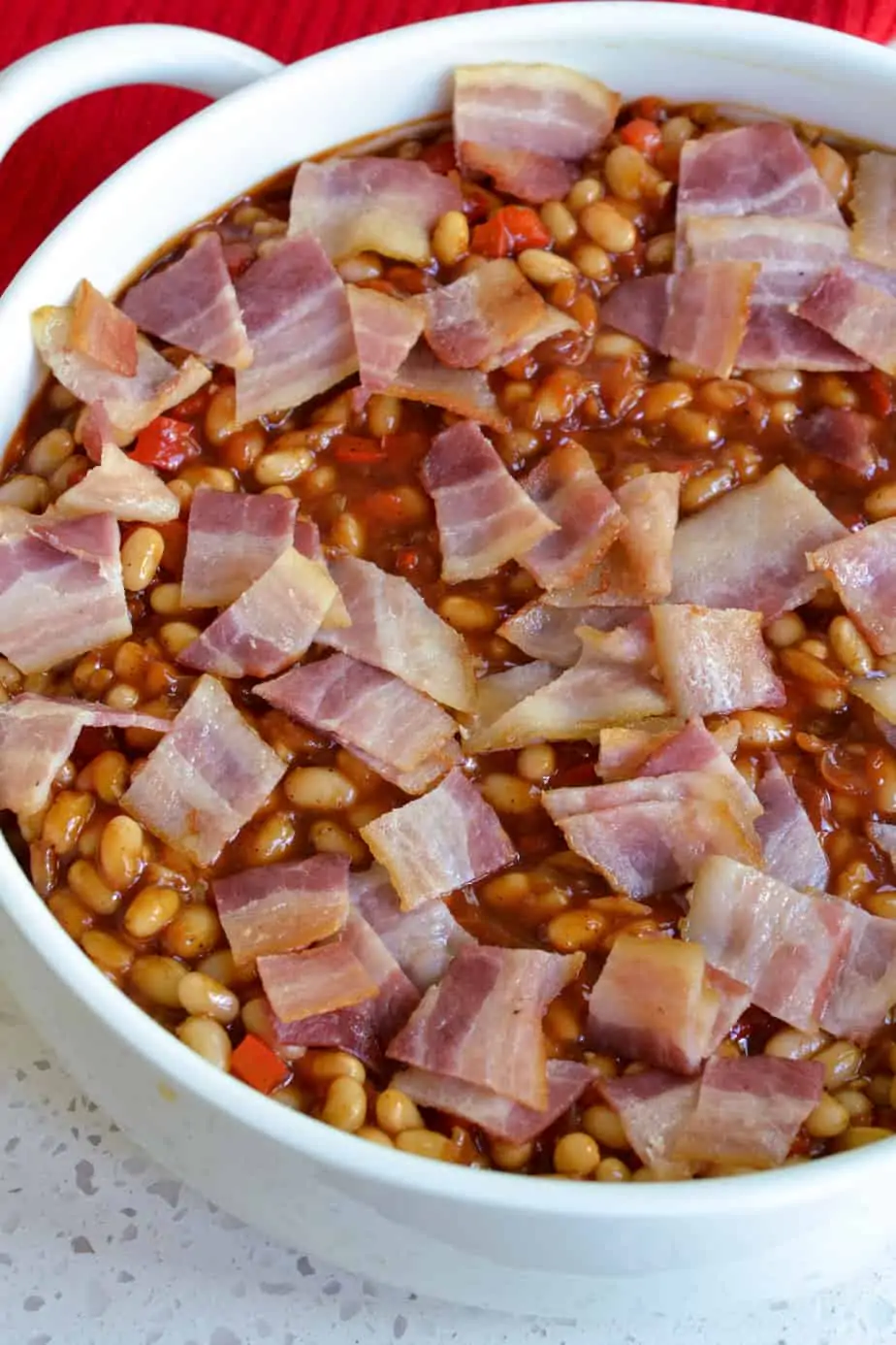  Chop the bacon into bite-size pieces and sprinkle the partially cooked bacon over the top. 