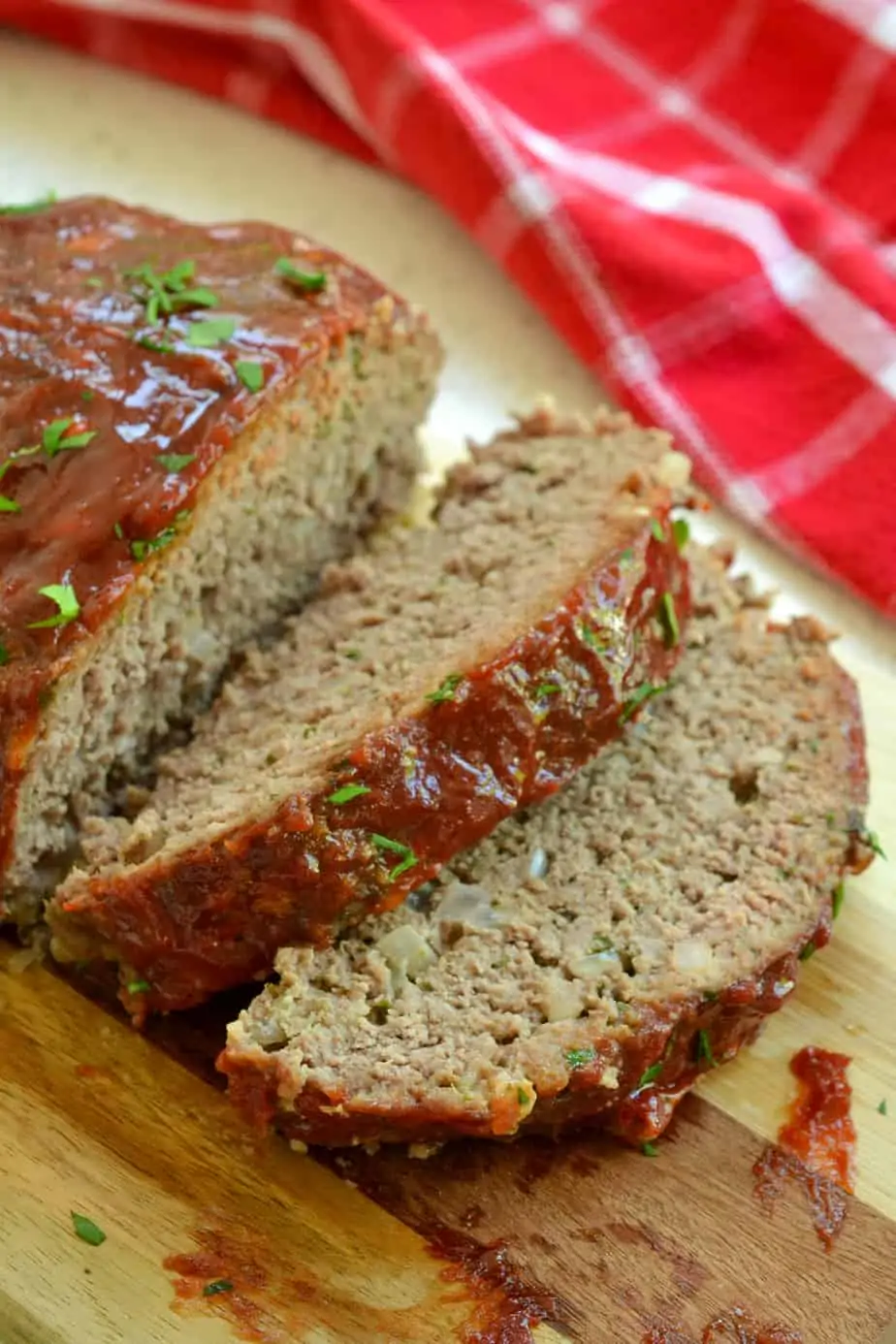 Slices of homemade meatloaf on a cutting board. 