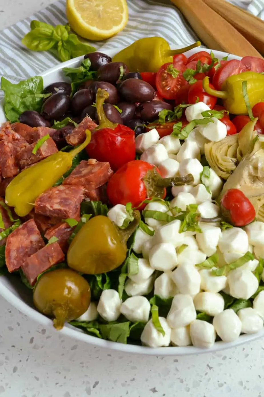 A close up view of antipasto salad in a bowl. 