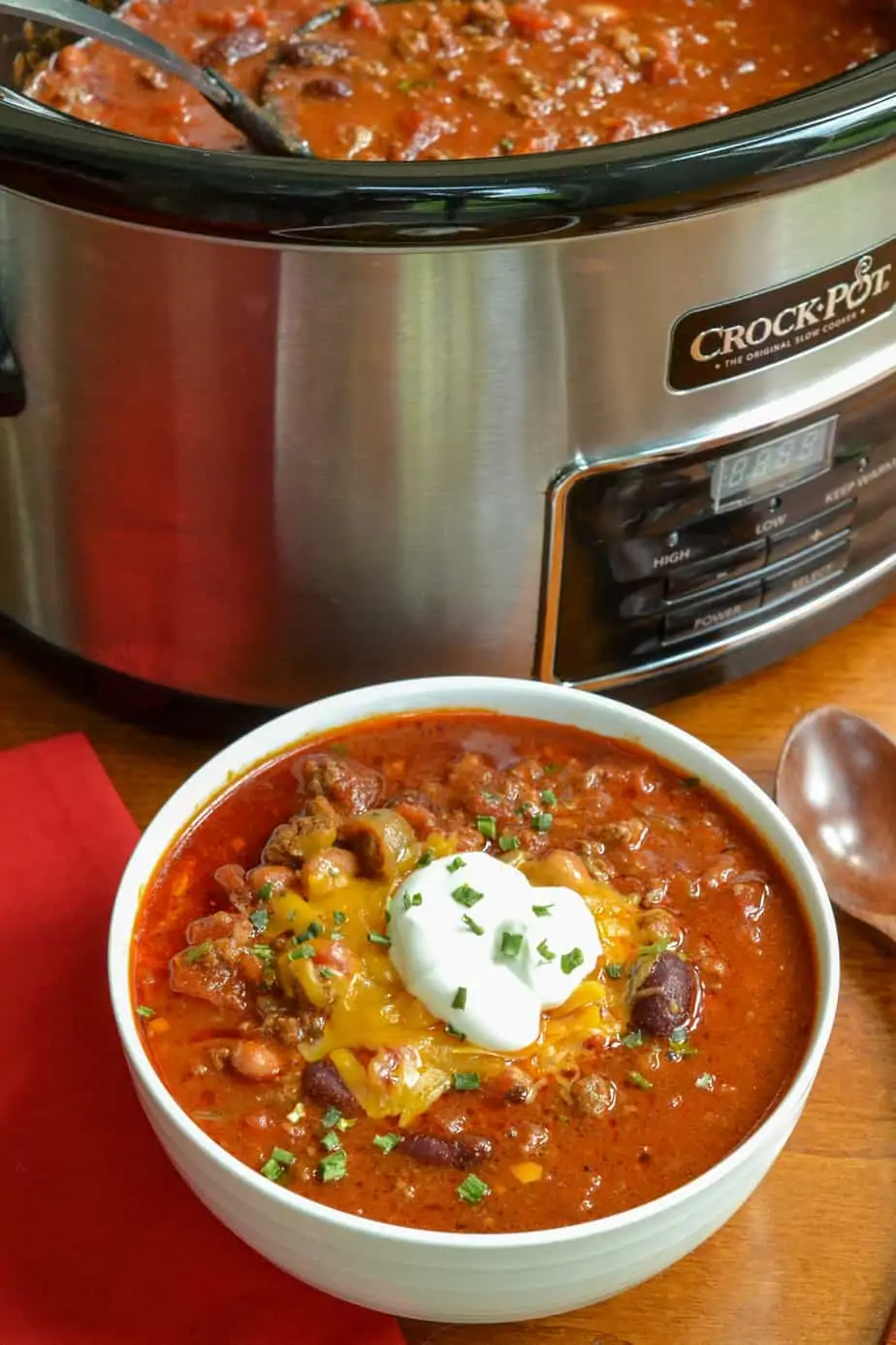 A crock and a bowl full of chili
