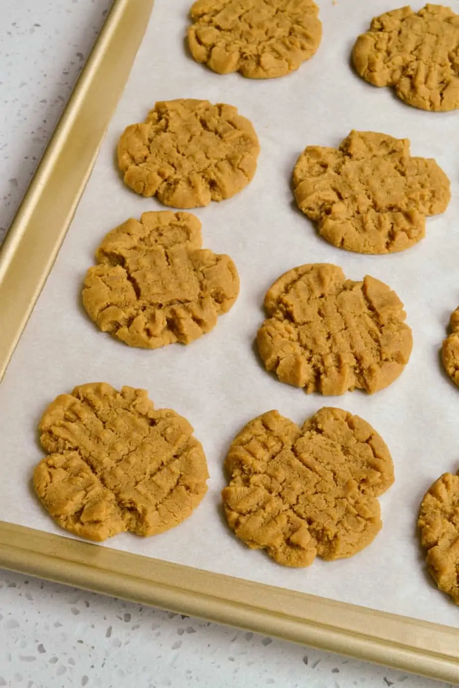 Baked flourless peanut butter cookies on a baking sheet. 