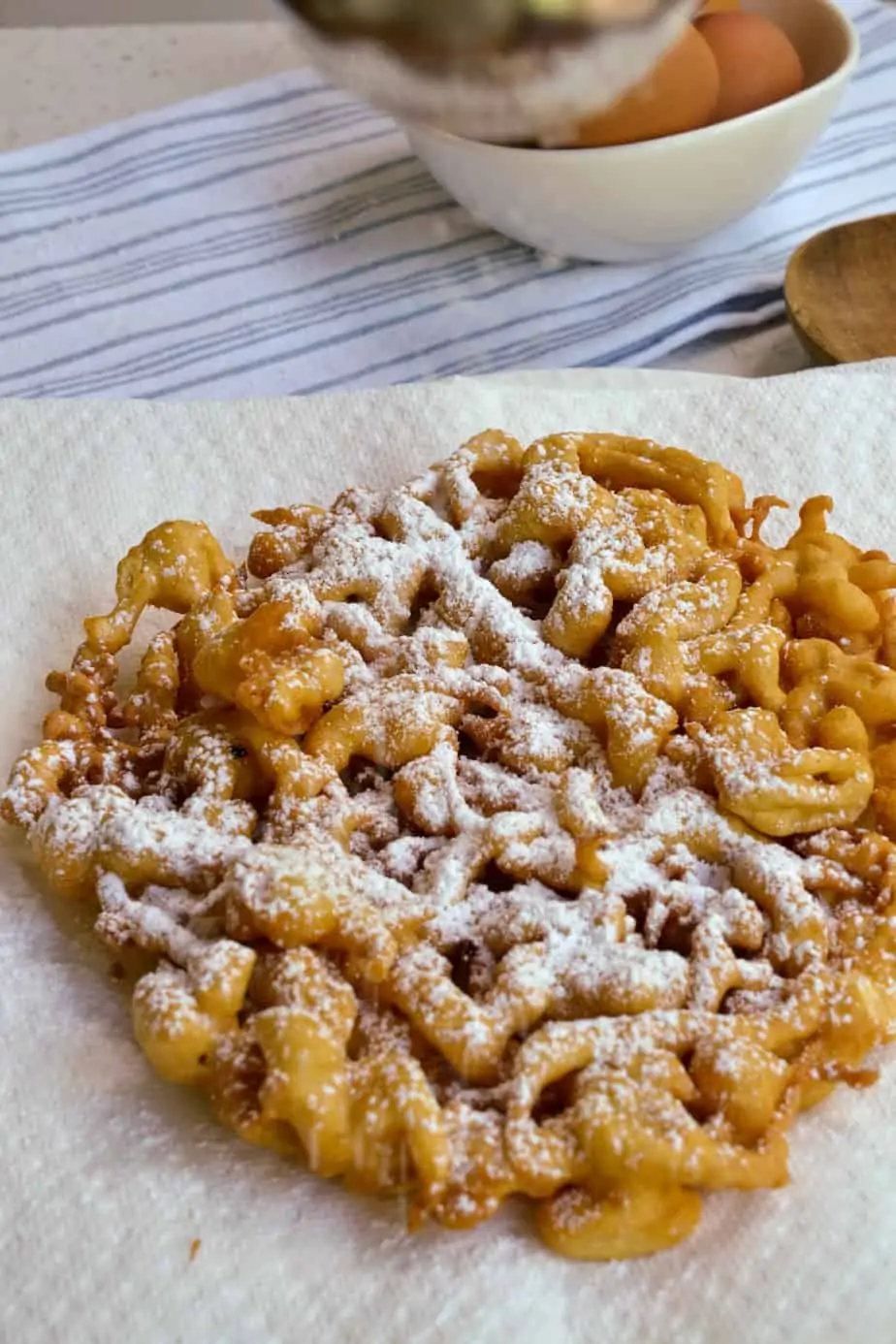 Homemade funnel cakes dusted with powdered sugar. 