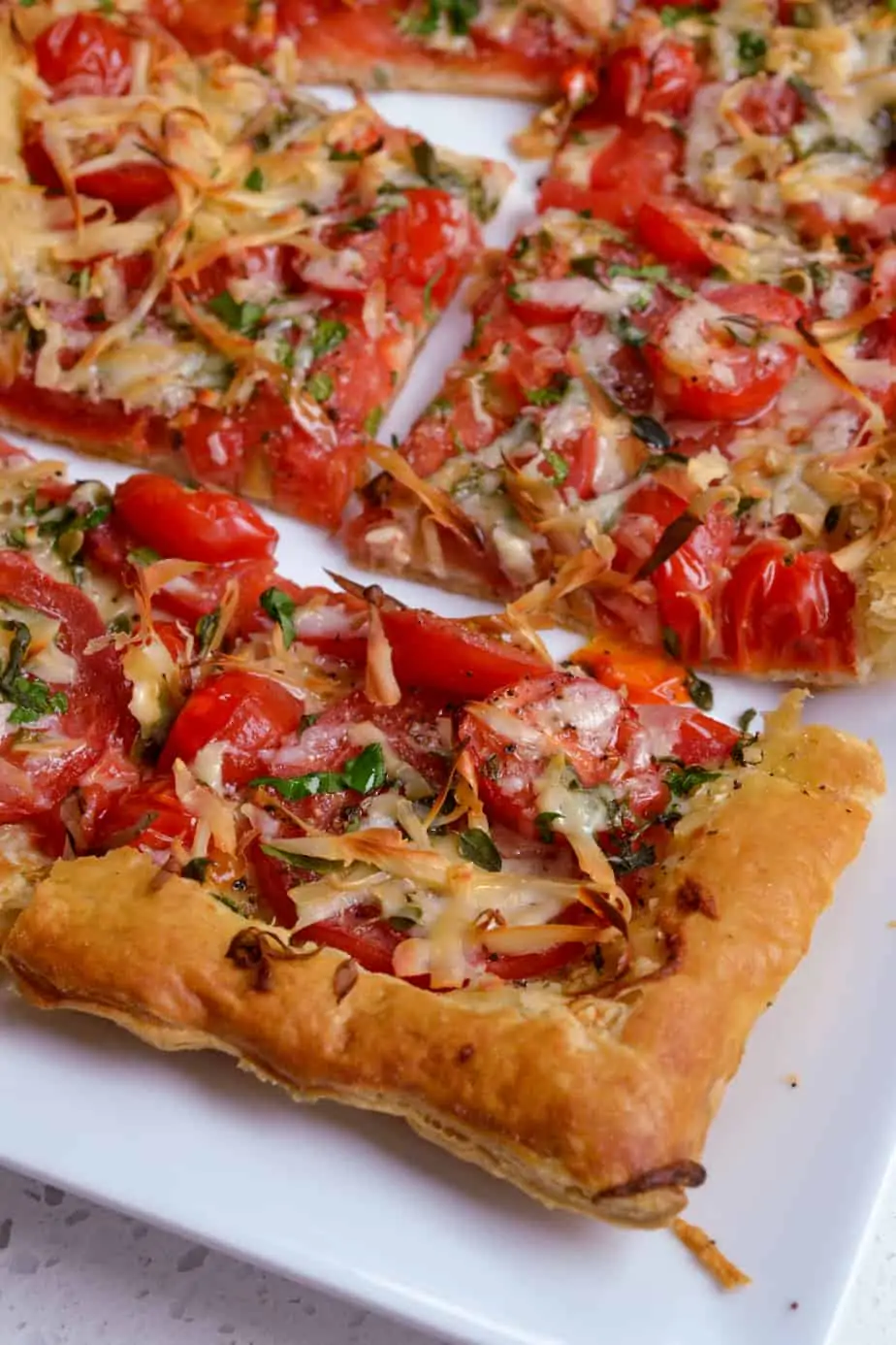 Perfect for entertaining, these tomato tarts are easy to assemble, so beautiful, and amazingly delicious with the taste of fresh sun-ripened tomatoes and a mixture of fresh herbs. 