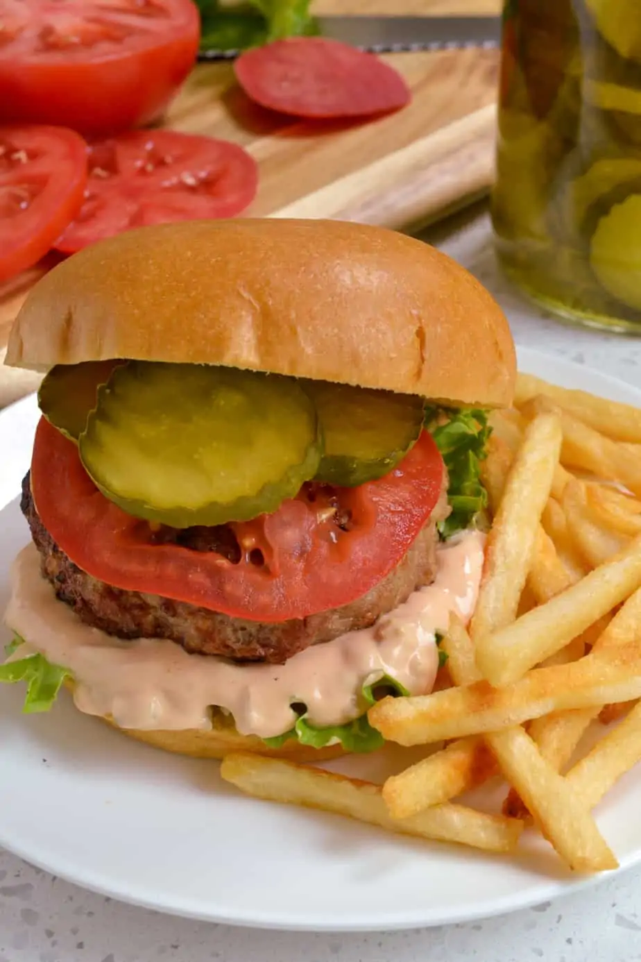 Turkey burger with burger sauce and fries. 