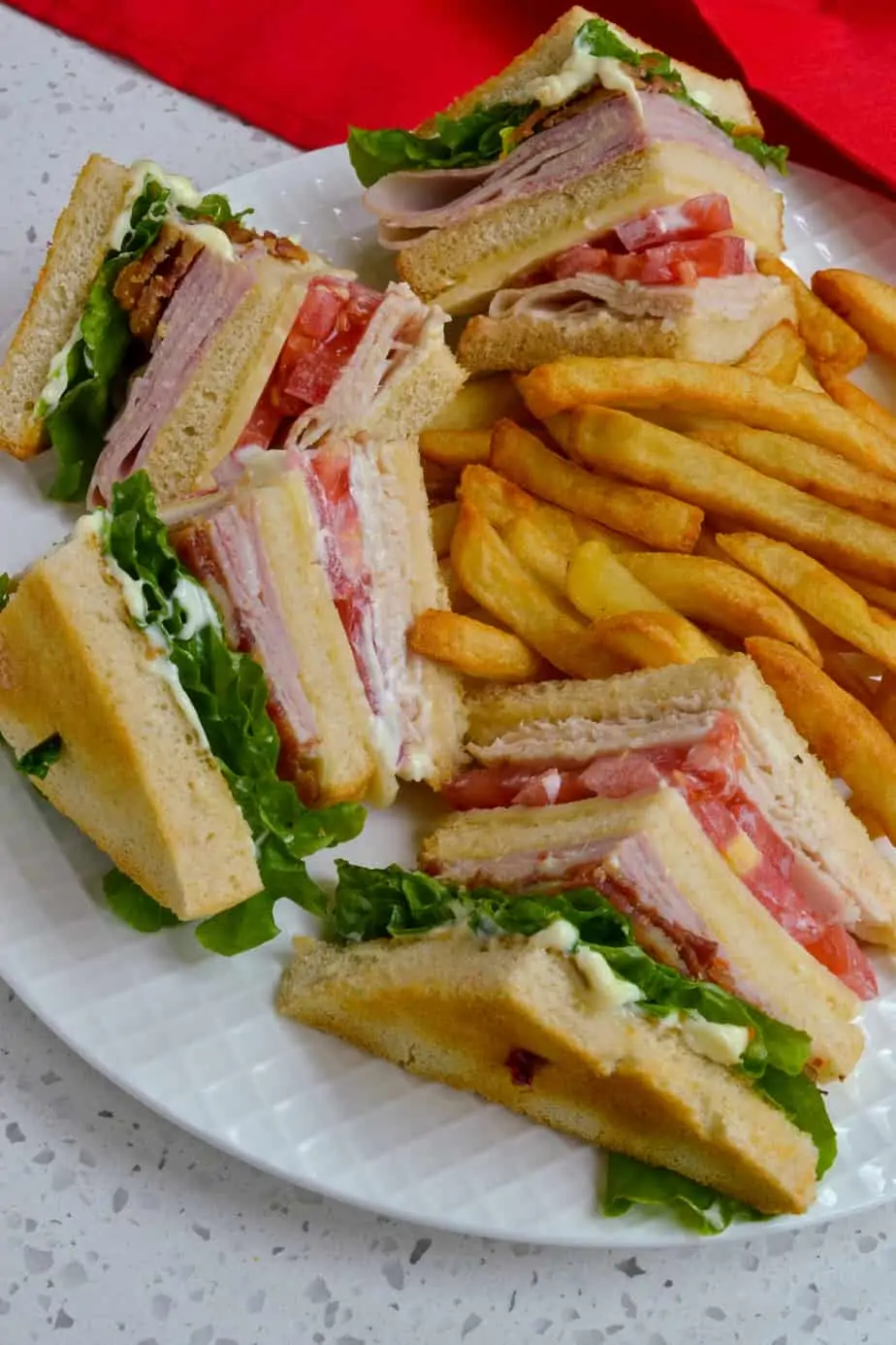 A classic club sandwich served with French fries. 