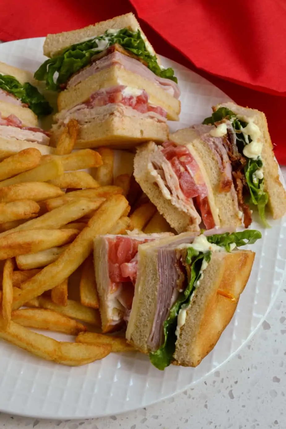 Quartered Club Sandwich served with French fries. 