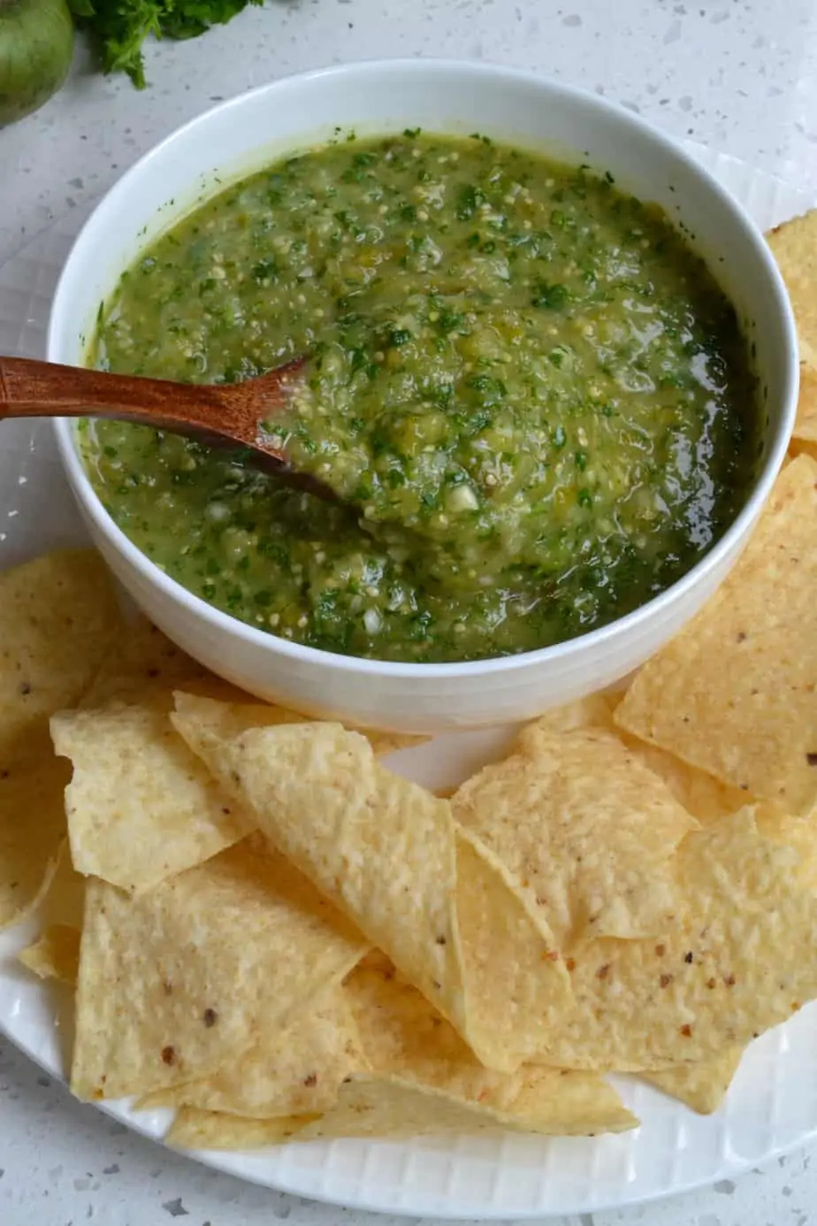 A spoonful of fresh salsa made from tomatillos. 
