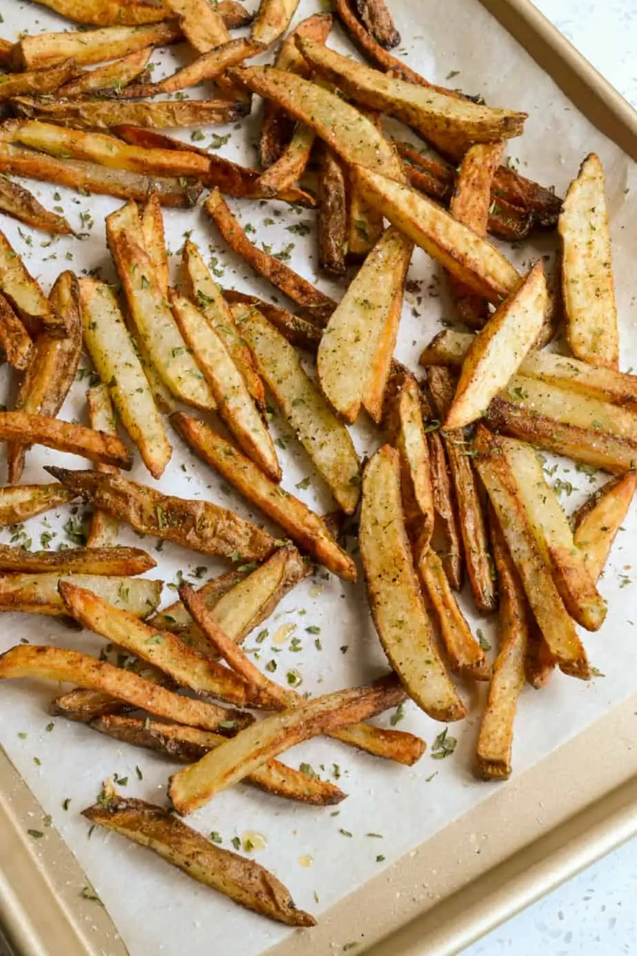 A baking sheet full of crispy fries. 