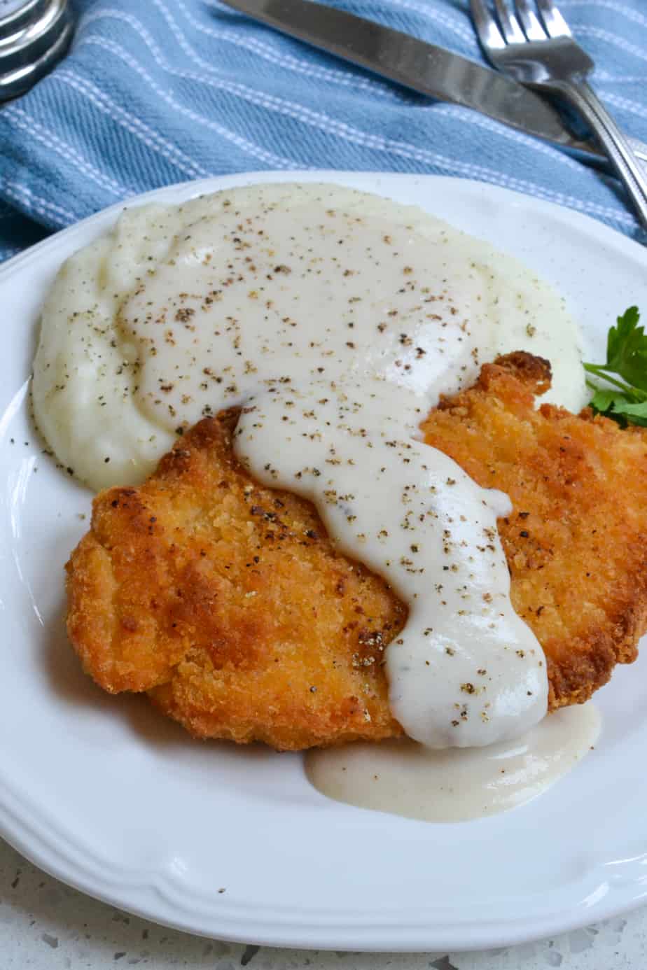 White peppered gravy over crispy chicken and mashed potatoes. 