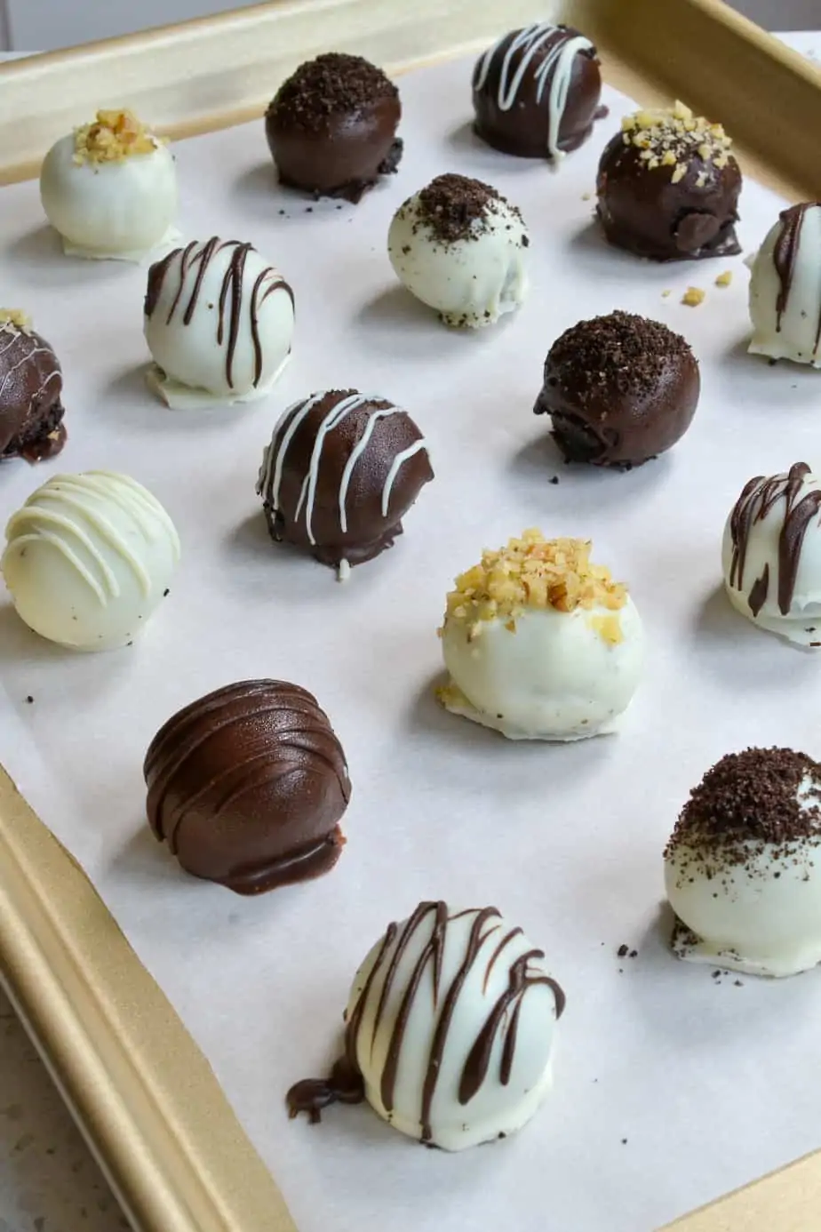 Scrumptious Oreo Truffles are made easy with a food processor and dipped in melted white and dark chocolate. 