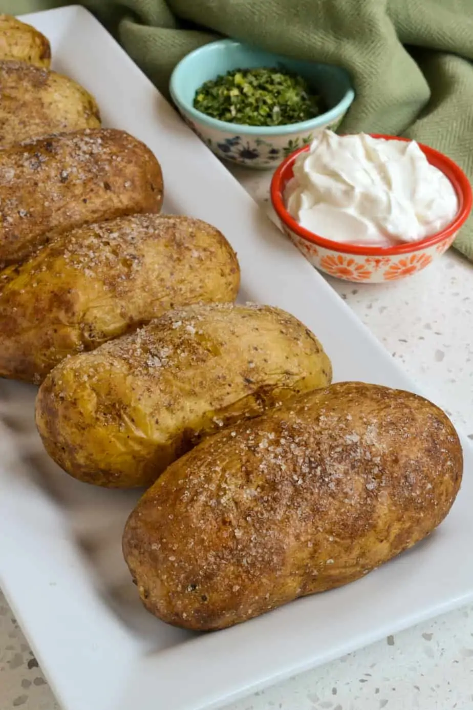 A platter of oven baked potatoes fresh out of the oven. 