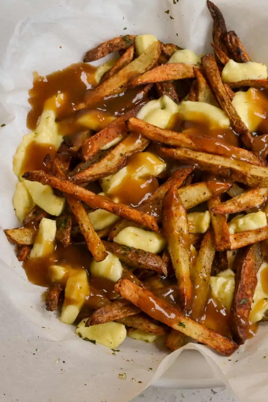 Poutine Recipe with crispy fries, cheese curds, and beefy gravy. 