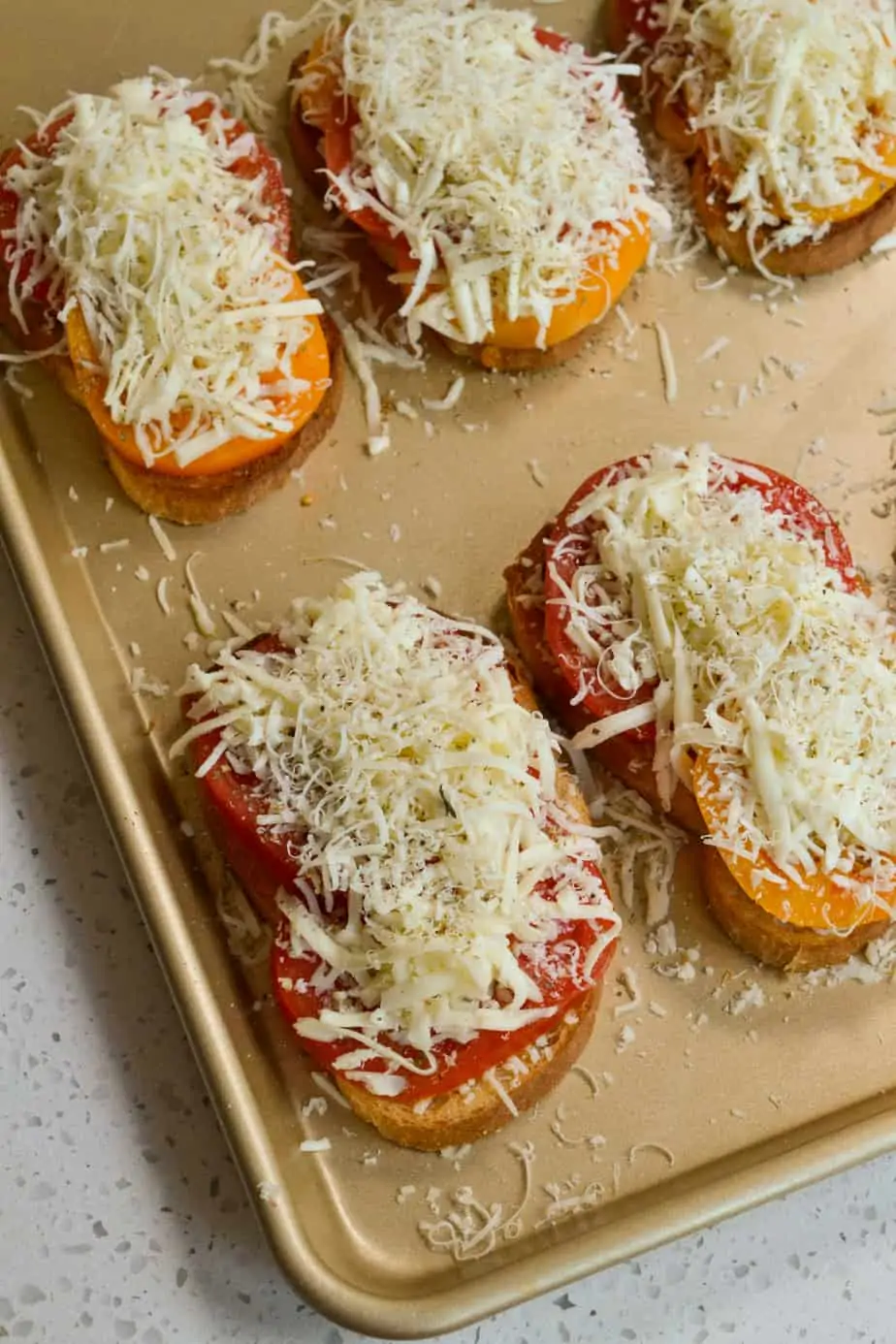 Top the tomato sandwiches with shredded mozzarella and parmesan. 