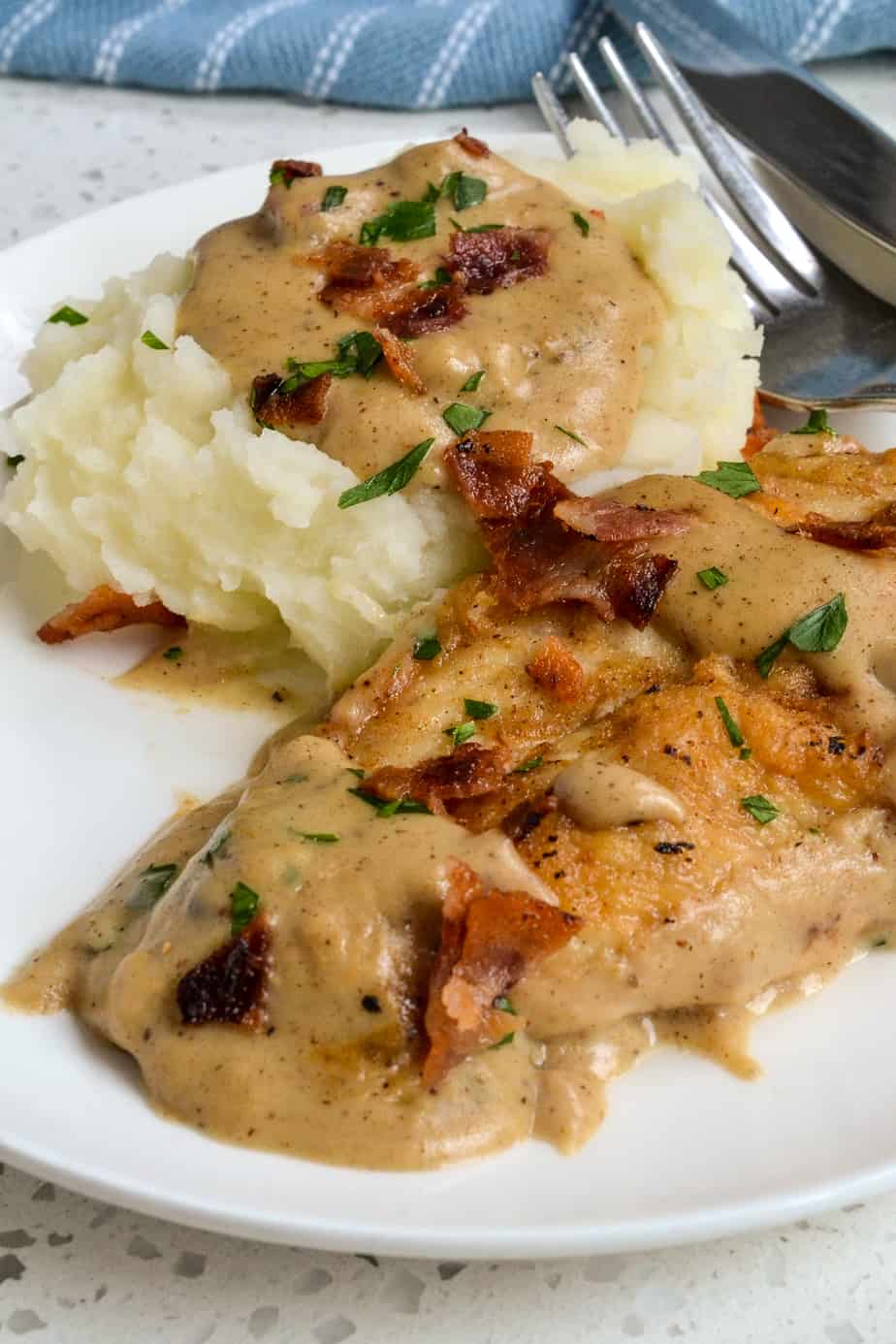 Chicken and mashed potatoes with bacon and gravy. 