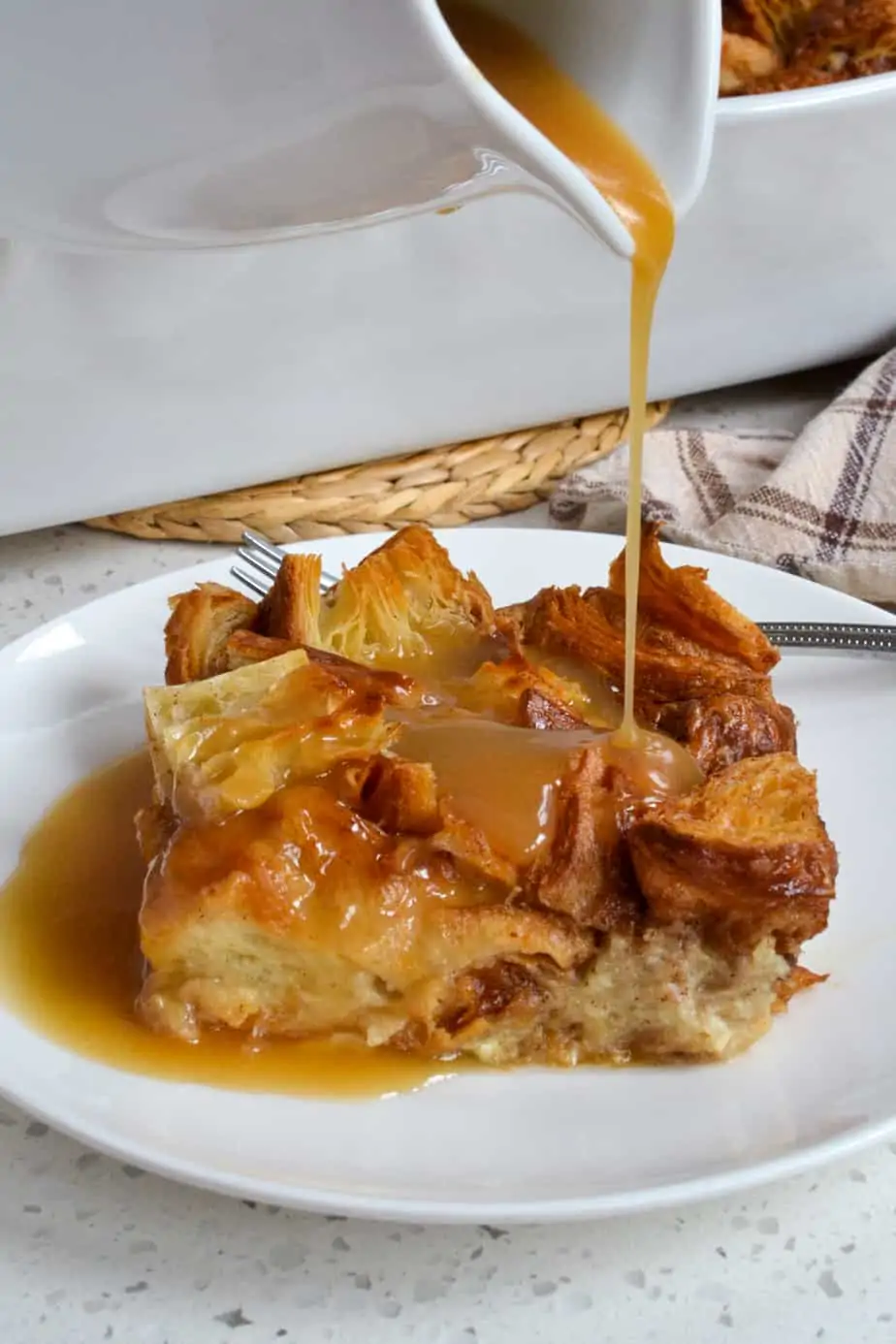 Warm vanilla sauce drizzled over Croissant Bread pudding.