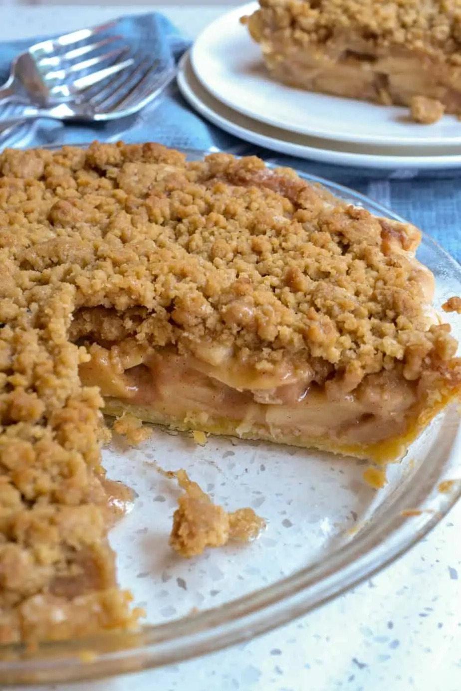 An Apple Crumb Pie with a slice cut out of it. 