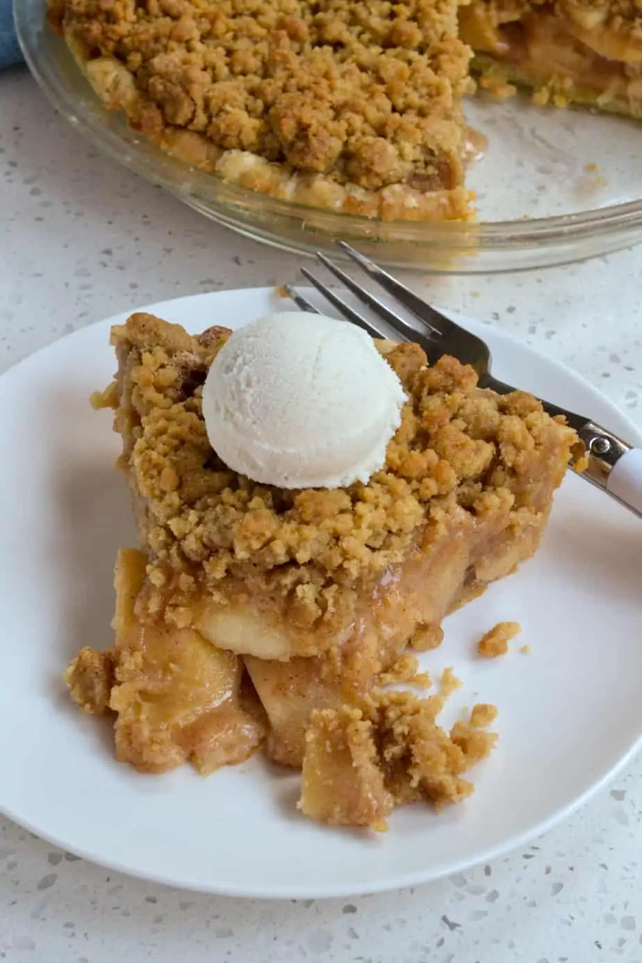 A homemade Dutch Apple Pie with a fresh flaky crust, tender granny smith and pink lady apples, and oodles of butter crumb topping.