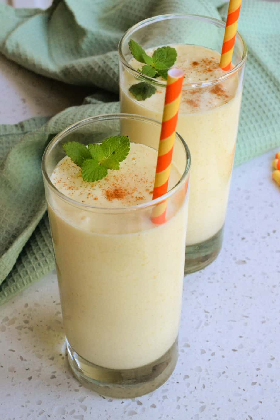 Glasses of mango smoothie with mint and cardamom. 
