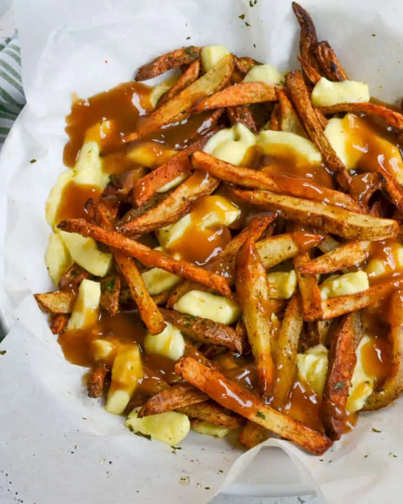 Poutine Recipe with crispy fries, cheese curds, and beefy gravy. 