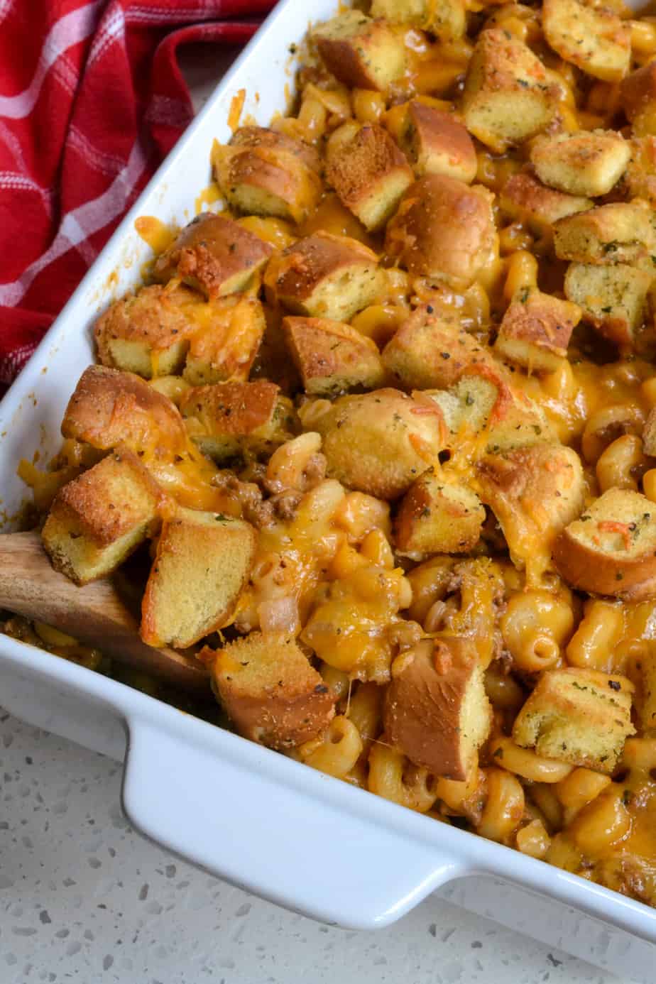 A fun and easy Cheeseburger Casserole with ground beef, onion, garlic and pasta in a cheesy sauce topped with more cheese and fresh homemade bun croutons.