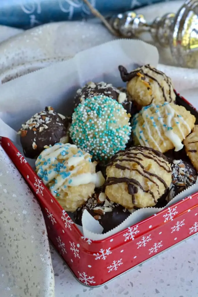 A tin full of decorated coconut macaroons. 