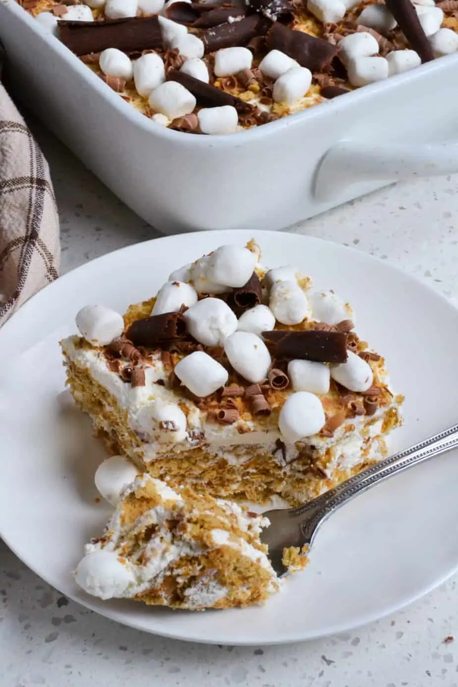 A slice of old fashioned ice box cake with a bite on a fork. 