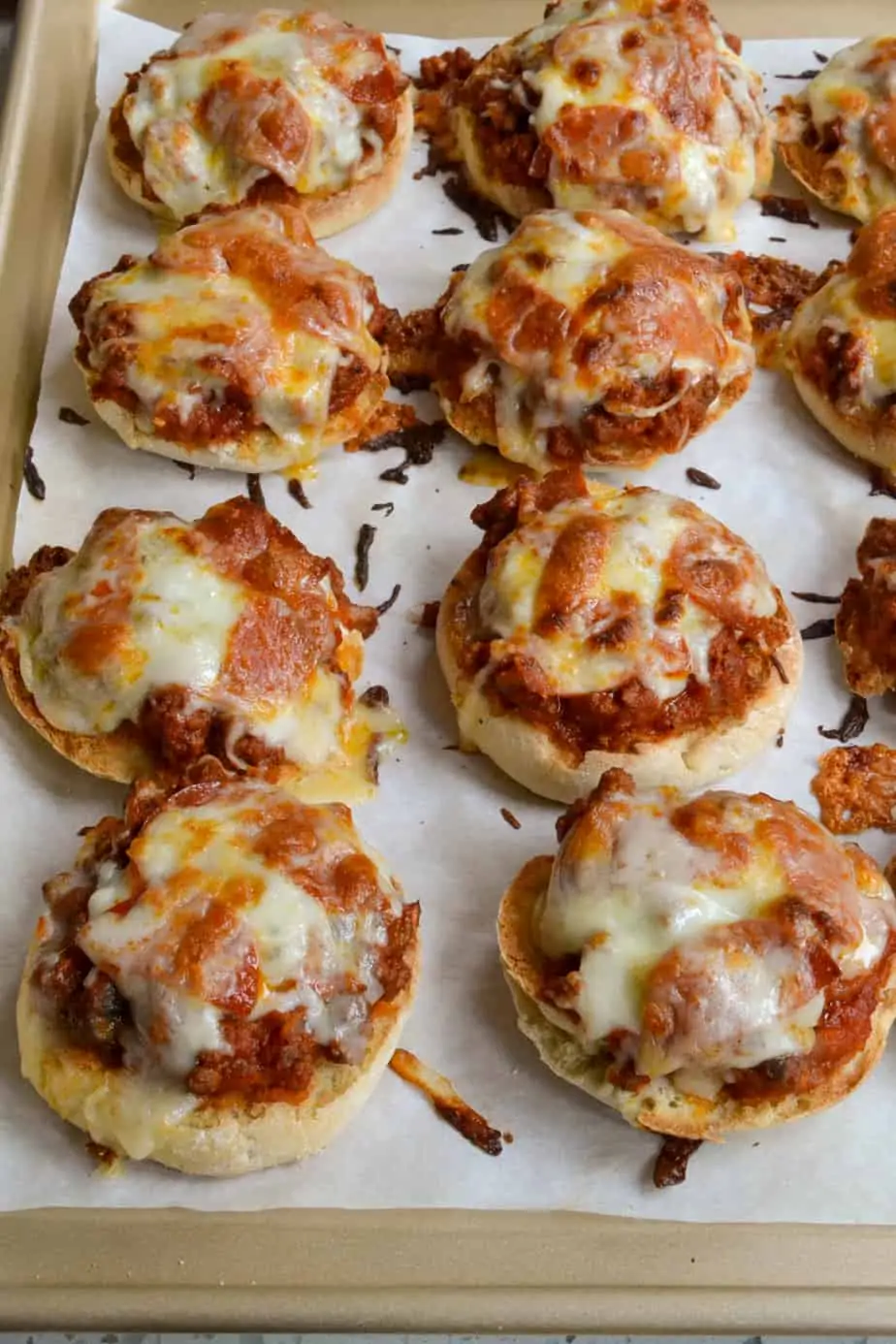 English muffins topped with browned hamburger, onions, marinara, and cheese. 