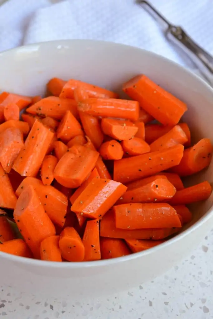 A bowl of seasoned sliced carrots. 