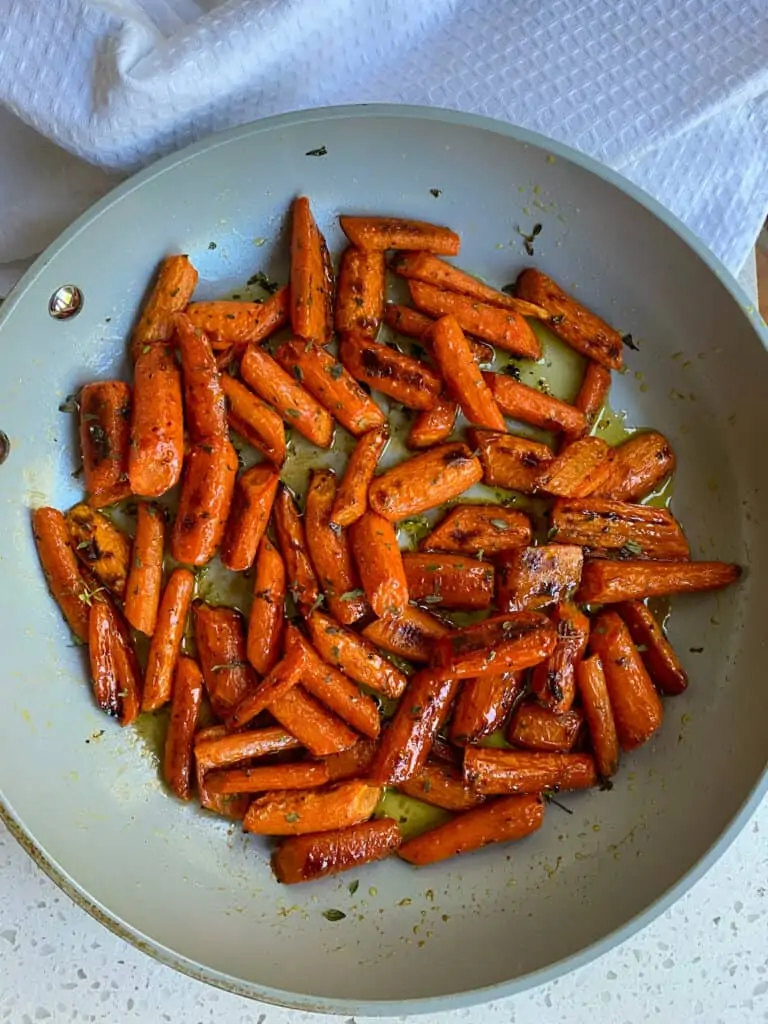 A skillet full of Honey Roasted Carrots