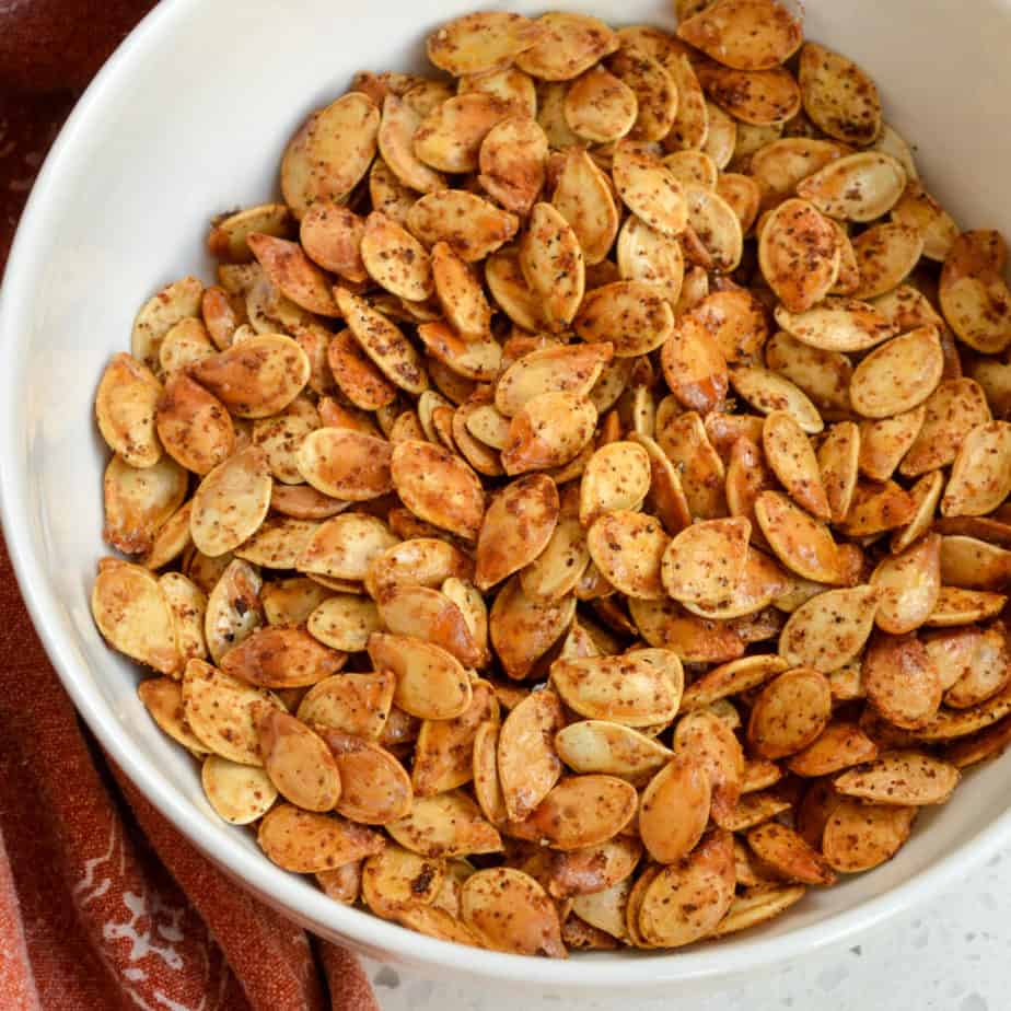 A bowl full of crispy roasted pumpkin seeds. 