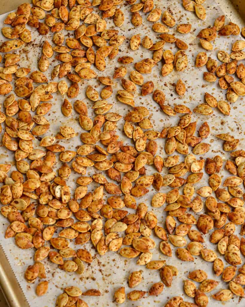 Roasted Pumpkin Seeds on a lined baking sheet.