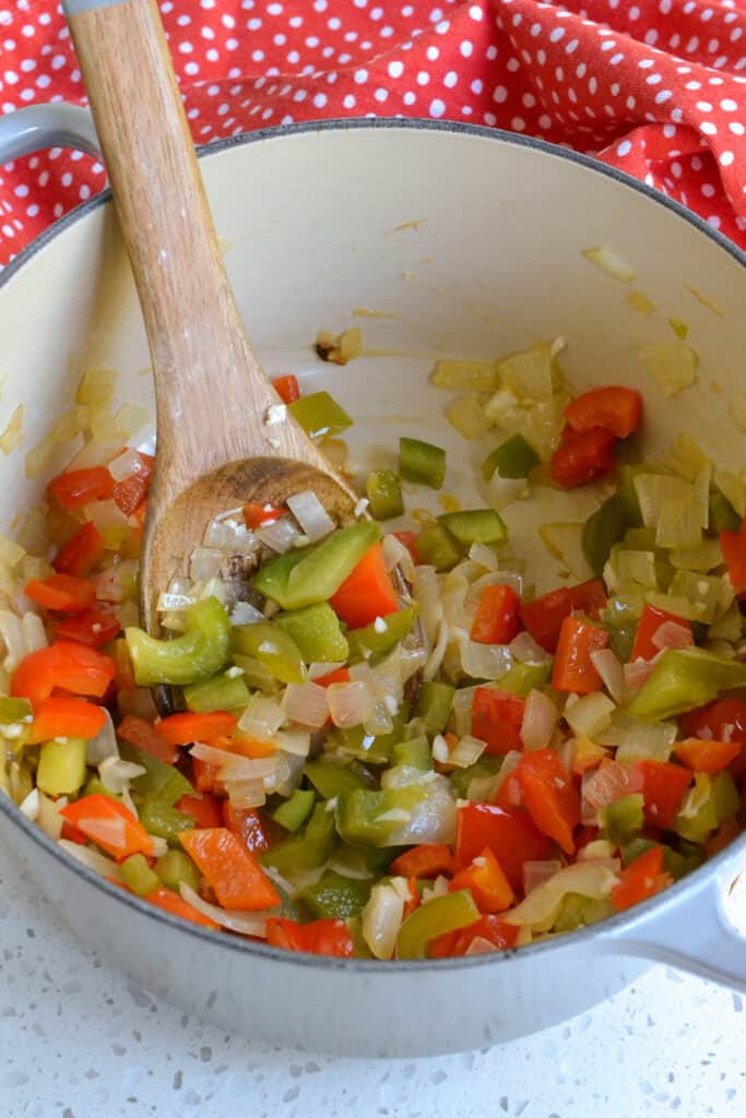 Cook the onions, red and green bell peppers until soft.