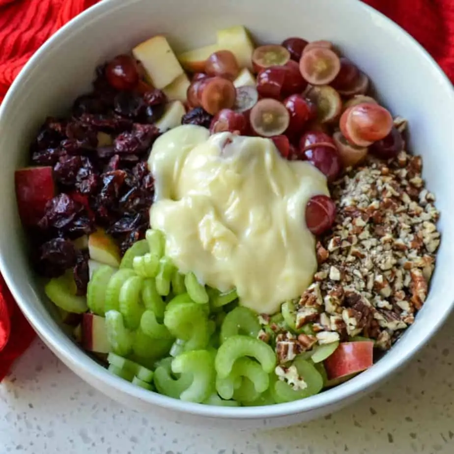 Add all the ingredients to make apple salad to a big bowl. 