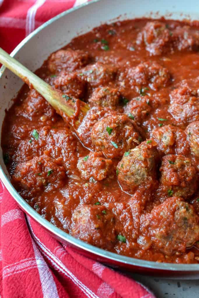 I skillet full of Italian Meatballs with homemade marinara sauce. 