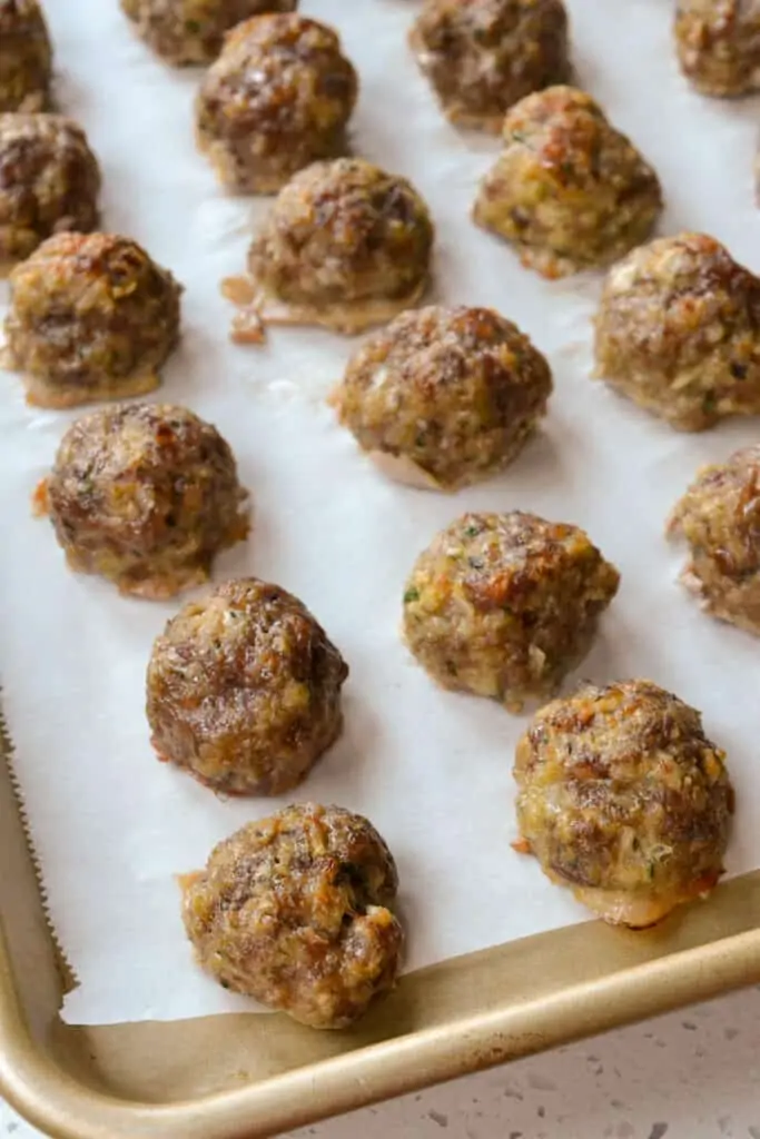 Place the raw meatballs on a baking sheet in a single layer with a little space between them. Bake for about 20 minutes in a preheated oven. 