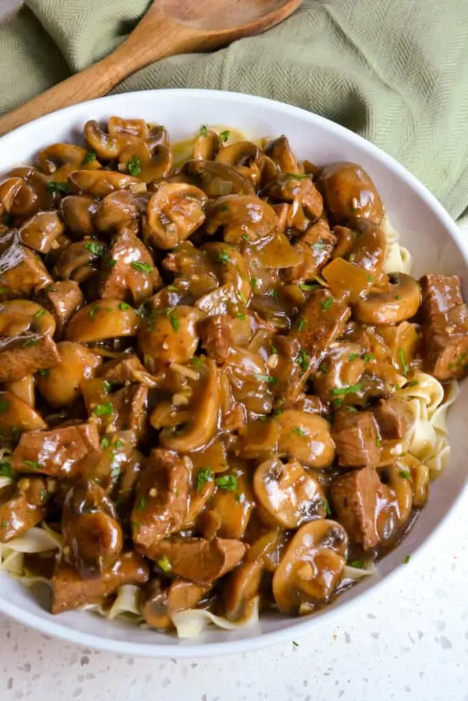 Beef with mushrooms and gravy over noodles. 